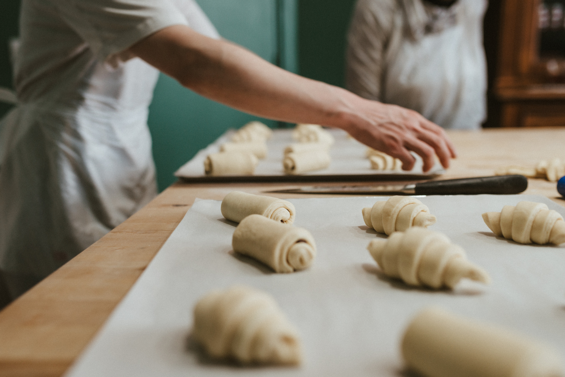 Students shaping croissant dough during a hands-on baking class in Baltimore